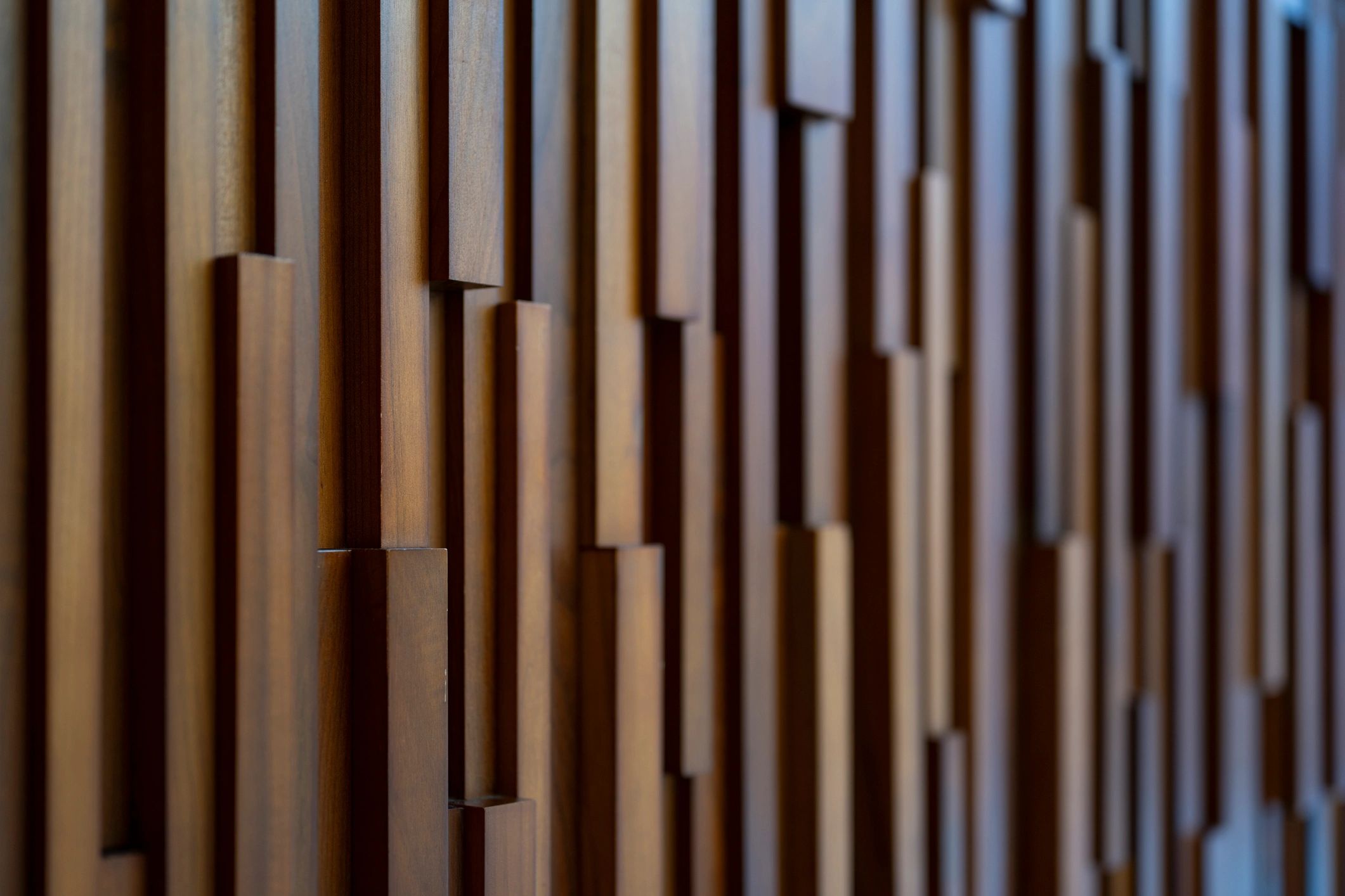 Vertical wood wall surface with warm tone and visible grain