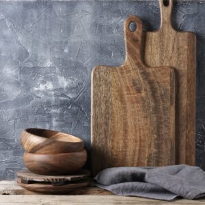 Sculpted wooden accent bowl/tray photographed in a warm studio setting